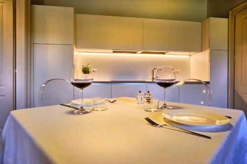 a table with two glasses of wine on it at Relais Corte Guastalla Apartments in Sona