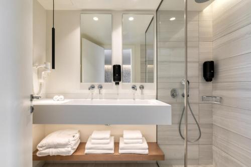 a bathroom with a sink and a shower at Utopia Blu Hotel in Tigaki