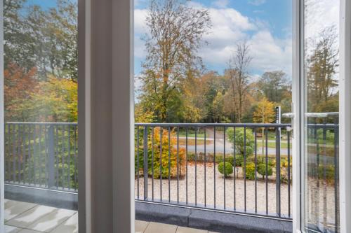 a window view of a garden from a balcony at Fletcher Boutique Hotel De Mallejan in Vierhouten