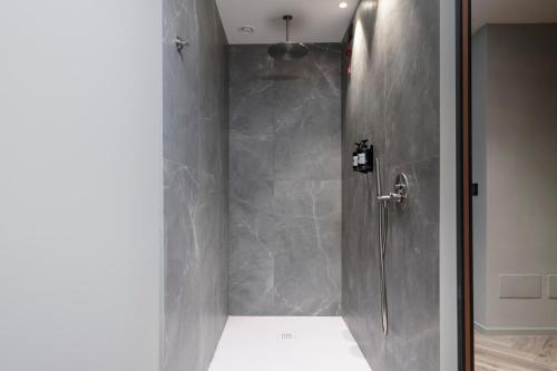 a shower with a glass door in a bathroom at Visionair Suites & SPA-Room Only e Honesty Bar in Senigallia