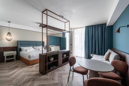 a hotel room with a bed and a table at Visionair Suites & SPA-Room Only e Honesty Bar in Senigallia