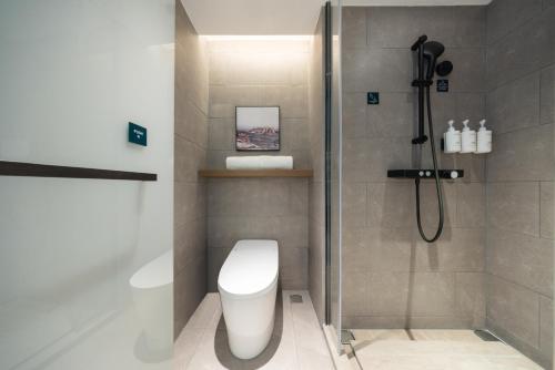 a bathroom with a shower and a toilet at Atour Hotel Beijing Temple of Heaven East Gate Longtan Park in Beijing
