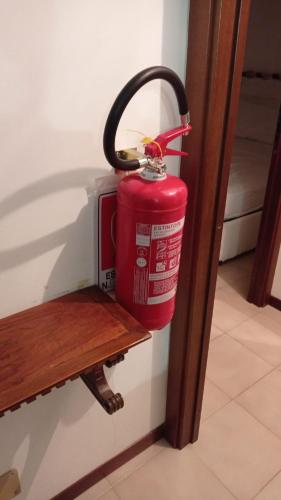 a fire hydrant is hanging on a wall at La casa di Teri a Chiavari in Chiavari
