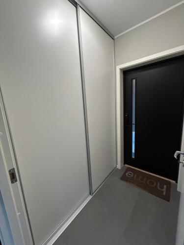 an empty room with a sliding glass door at Eide Aurora Apartement in Tromsø