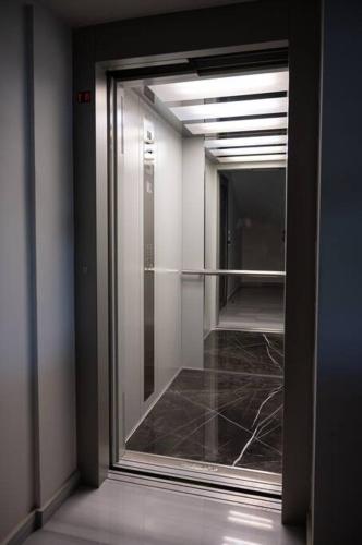 a hallway with a glass door in a building at LYAN Cozy Apartment by HOME SH in Nafplio