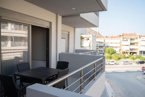 a balcony with a table and chairs on a building at LYAN Cozy Apartment by HOME SH in Nafplio