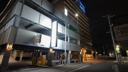 a lit up building on a city street at night at Toyoko Inn Koriyama in Koriyama