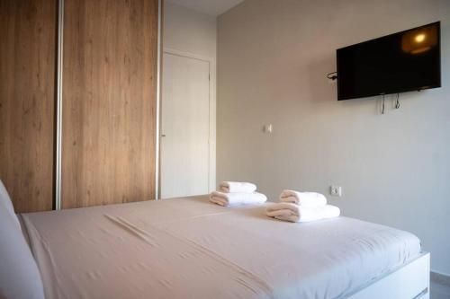 a bedroom with a bed with towels on it at LYAN Cozy Apartment by HOME SH in Nafplio