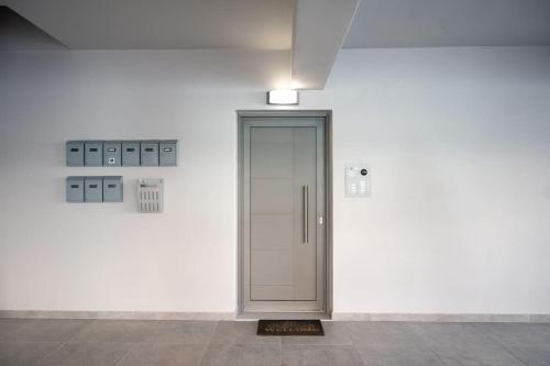 a hallway with a door in a white wall at LYAN Cozy Apartment by HOME SH in Nafplio