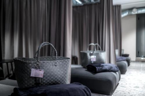two bags sitting on a couch in a hotel room at Hotel Esplanade Dortmund in Dortmund
