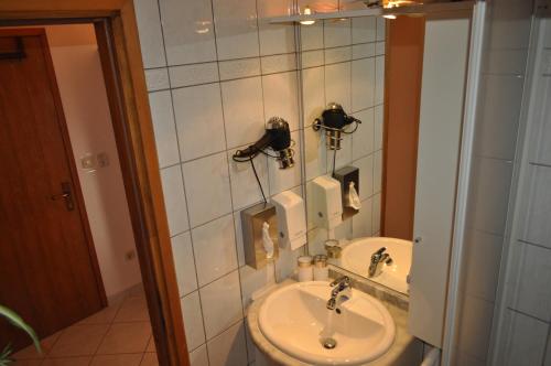a bathroom with a sink and a toilet at Studios Lav in Privlaka