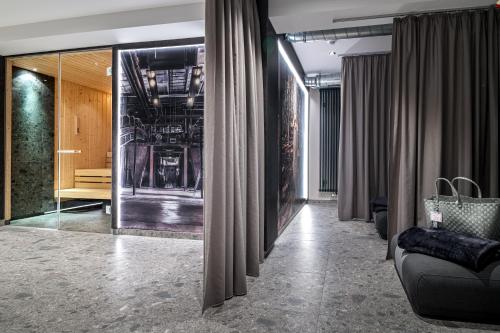 a hallway with curtains and a couch in a room at Hotel Esplanade Dortmund in Dortmund