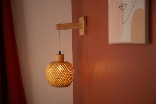 a pendant light hanging from a wall in a room at La Maison du Parc in Digoin