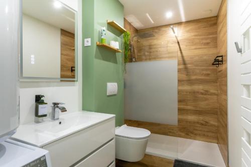 a bathroom with a toilet and a shower at La Maison du Parc in Digoin
