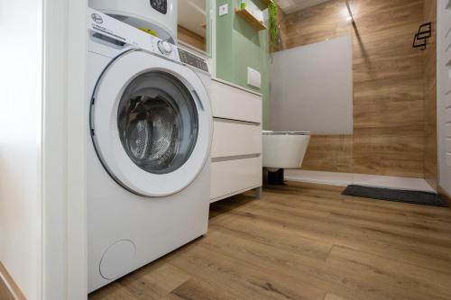 a laundry room with a washer and dryer at La Maison du Parc in Digoin