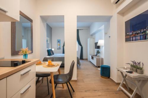a kitchen and living room with a bed and a table at D&A Amphitheatre Apartments with free parking in Pula