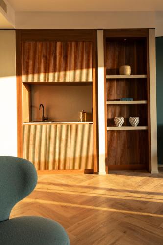 a room with a kitchen with wooden floors and shelves at Visionair Suites & SPA-Room Only e Honesty Bar in Senigallia