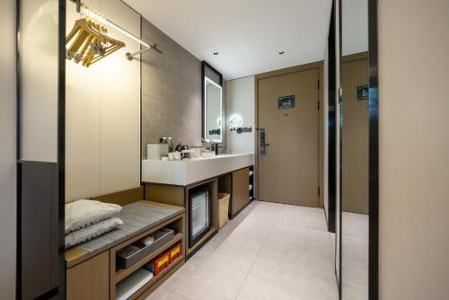 a bathroom with a sink and a mirror at Atour Hotel Beijing Temple of Heaven East Gate Longtan Park in Beijing