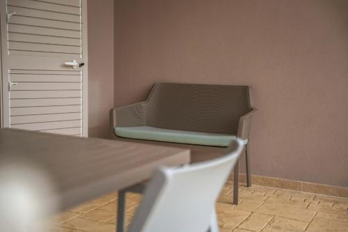 a room with a chair and a table and a door at Villa Aris in Villa Gorizia