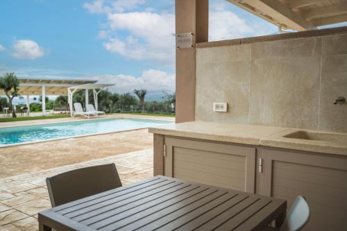 a kitchen with a table and a swimming pool at Villa Aris in Villa Gorizia