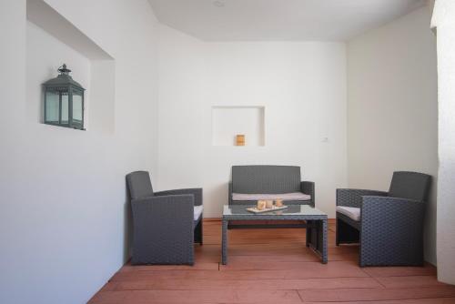 a waiting room with chairs and a table and a lamp at D&A Amphitheatre Apartments with free parking in Pula