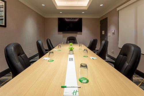 a conference room with a long wooden table and chairs at Holiday Inn Hotel & Suites Maple Grove Northwest Minneapolis-Arbor Lakes by IHG in Maple Grove