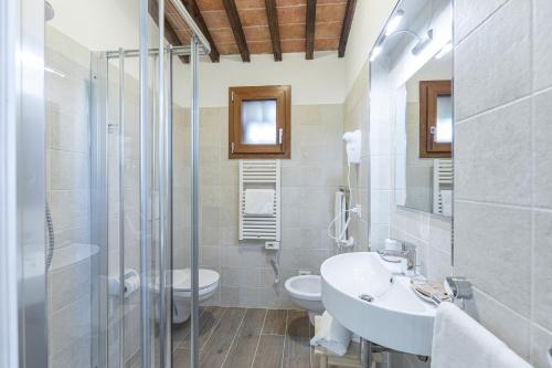 a bathroom with a sink and a toilet and a shower at Il Poderino in Monteriggioni