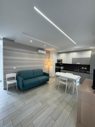 a living room with a couch and a table and chairs at Residence Cervia in Cervia