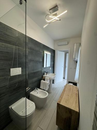 a bathroom with a toilet and a sink and a shower at Residence Cervia in Cervia