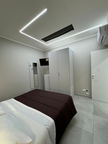 a white bedroom with a bed and aokedokedokedoked at Residence Cervia in Cervia