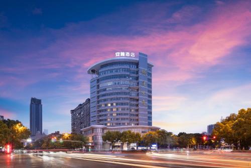 a building with a sign on the top of it at Anya Hotel -Next to Jiefang West Bar Street 2 minutes to the subway station free coffee free laundry free gym, huge windows in Changsha