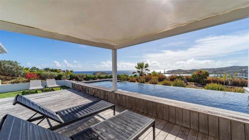 a house with a swimming pool and a patio at Haven of peace villa in a perfect setting in Marigot