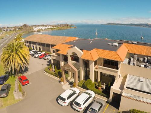 an aerial view of a house with cars parked in a parking lot at Millennium Hotel & Resort Manuels Taupo in Taupo