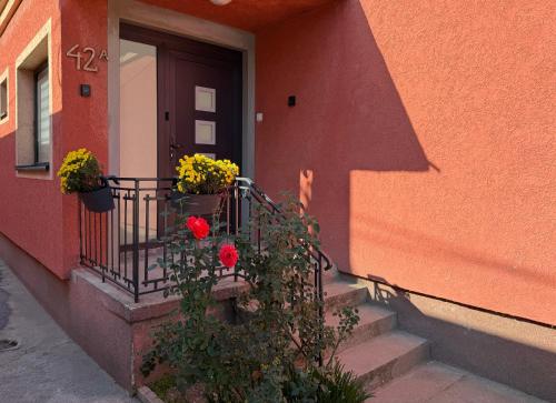 a house with a balcony with flowers on it at Hestia Suite in Zaječar