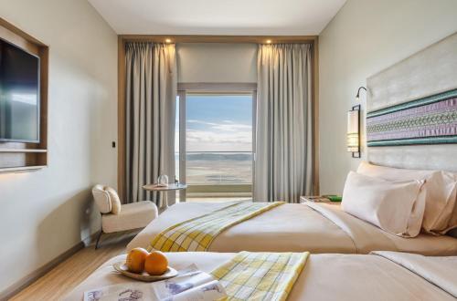 a hotel room with a large bed and a window at Ngorongoro Lodge member of Melia Collection - The Leading Hotels of the World in Ngorongoro