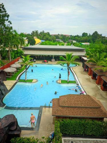 a pool at a resort with people in it at Hideaway Resort Banchang in Ban Chang