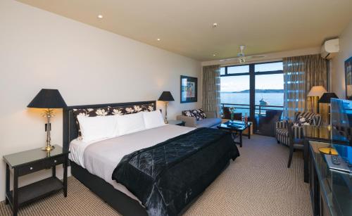 a hotel room with a bed and a television at Millennium Hotel & Resort Manuels Taupo in Taupo