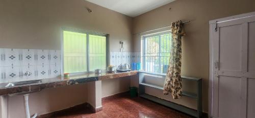 a kitchen with a sink and a window at Heath Cote in Ooty