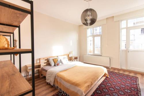 a bedroom with a bed and a large window at Soft and Historic 3BR Home w Iconic Haydarpasa View in Istanbul