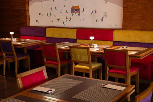 a dining room with wooden tables and chairs at DeSilva Warszawa Piaseczno in Piaseczno