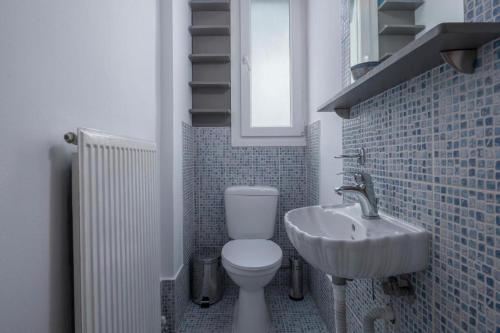 a small bathroom with a toilet and a sink at Melanthi urban in Volos