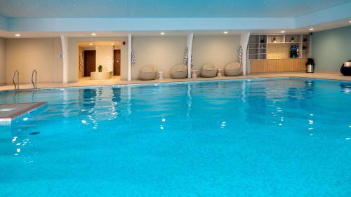 a large blue swimming pool in a hotel at St Moritz Hotel and Cowshed Spa in Polzeath
