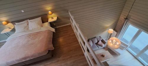 a bedroom with a bed and a staircase with a window at Au Bord de l'Eau in Vresse-sur-Semois