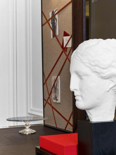 a white head statue on a table with a red box at Baccarat Hotel and Residences New York in New York