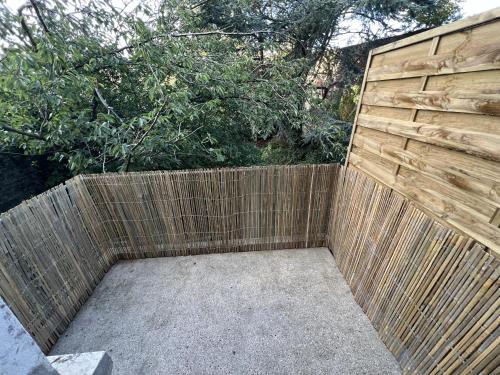 une arrière-cour avec une clôture et un mur en bois dans l'établissement Calais Wilson 2 - Studio Balneo 2p, à Calais