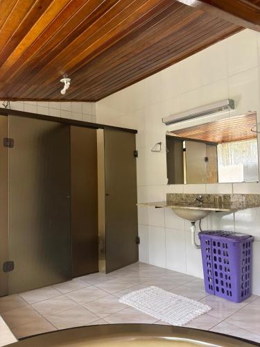 a bathroom with a door and a sink at Chácara A Grande Família in Sao Paulo