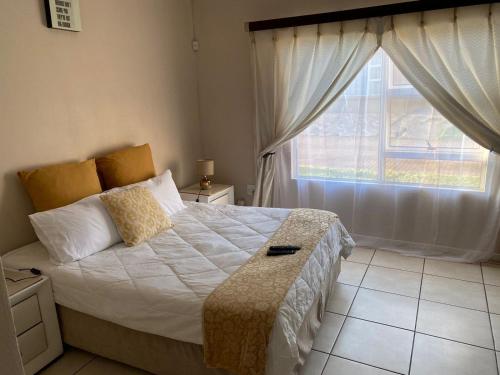 a bedroom with a large bed and a window at 16 on Swallow in East London