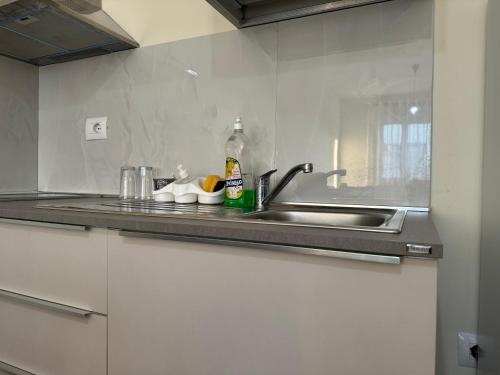 a kitchen with a sink and a counter top at Todhe Apartment - Gjiri Lalezit 500m from the beach in Draç