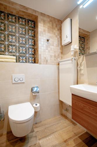 a bathroom with a toilet and a sink at Landhaus Müller in Alken