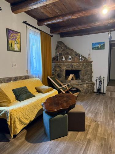 a bedroom with a bed and a stone fireplace at Nekreseli in Sagarejo